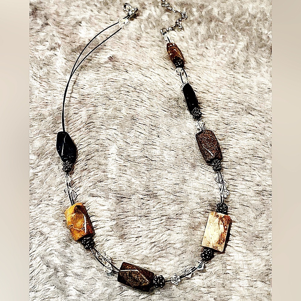 Necklace. Stones, shades of gray, black, brown.  Clear beads in between. 17“